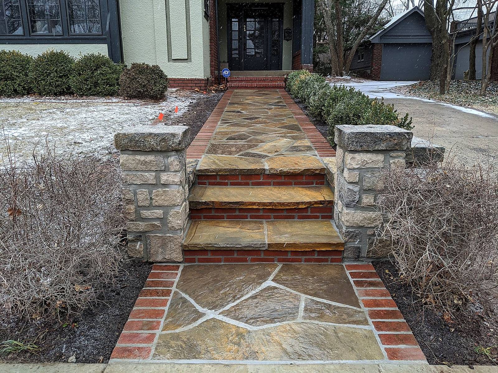 Stone piers, flagstone walk, and planter wall